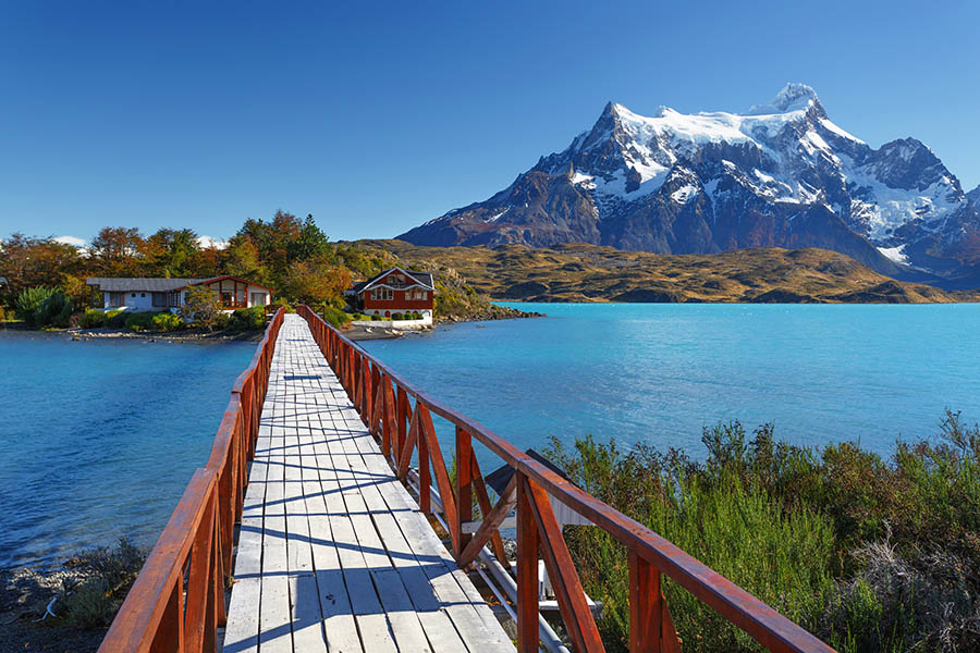 Follow the bridge to the famous house on the lake in Torres del Paine | Travel Nation