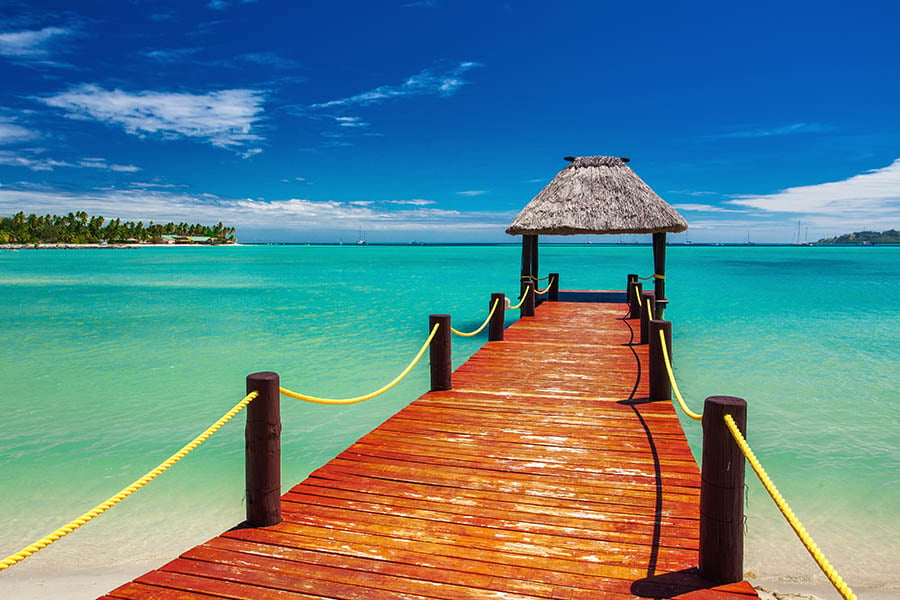 Jump off wooden piers into bright blue waters in Fiji | Travel Nation