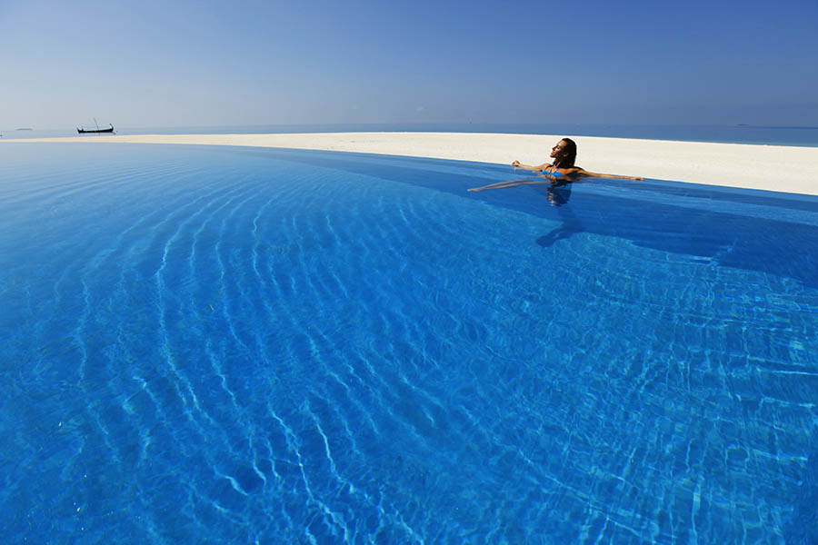 Swim in the stunning infinity pool at Velassaru Resort | Photo credit: Velassaru Resort