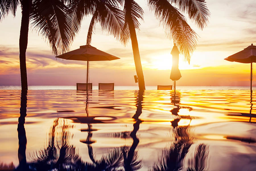 Relax around the pool at sunset in Thailand | Travel Nation