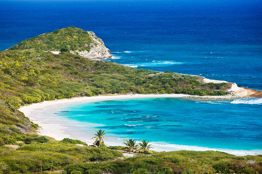 Stroll along the curve of Half Moon Bay in Antigua | Travel Nation