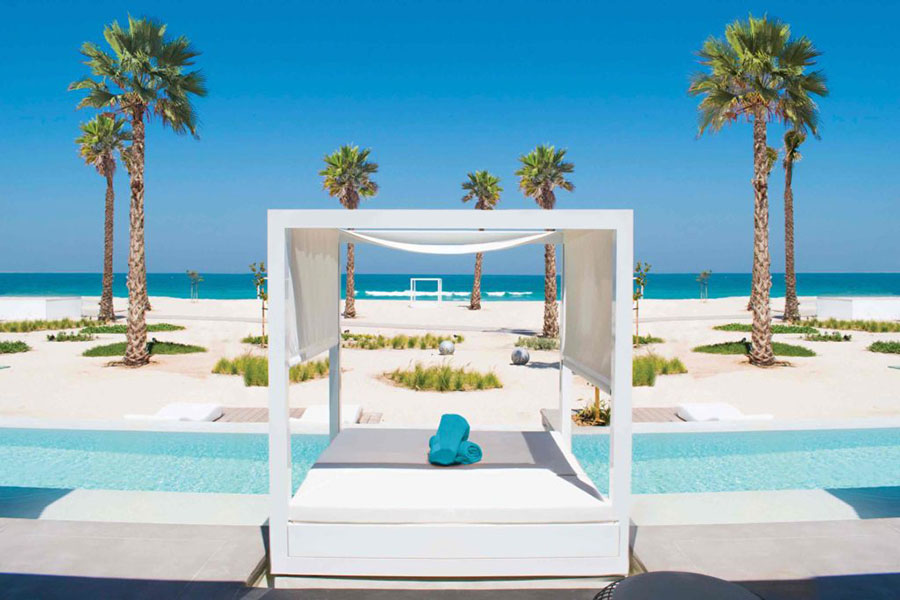 Relax by the pool at Nikki Beach Resort & Spa in Dubai | Photo credit: Nikki Beach Resort & Spa