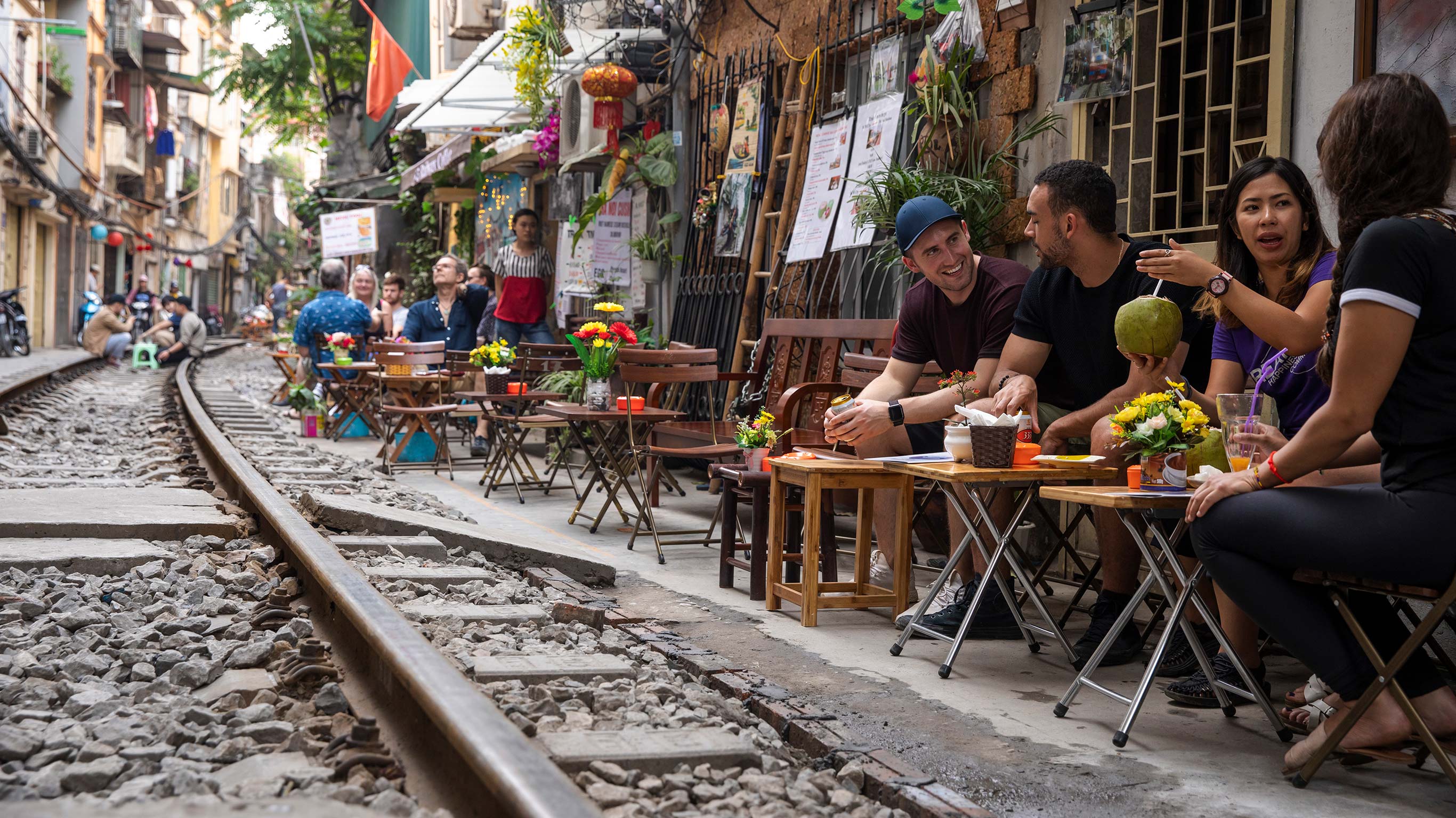 Vietnam-Hanoi-Train-Street-Cafe-Travellers-CEO-Sitting-Drinking