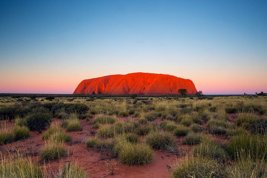 Watch the ever-changing colours of Uluru at sunset