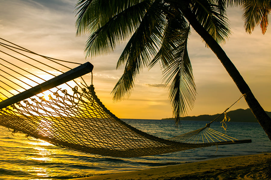 A hammock on the beach at sunset, Fiji | Fiji airways pass