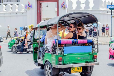 Explore the bustling streets of Bangkok by tuk-tuk
