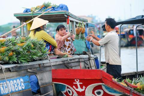 Journey into another world as you meander down the Mekong and watch fruit and veg being traded on the water
