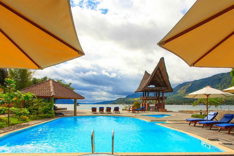 Relax by the pool at Lake Toba in Sumatra | Photo credit: Tabo Cottages