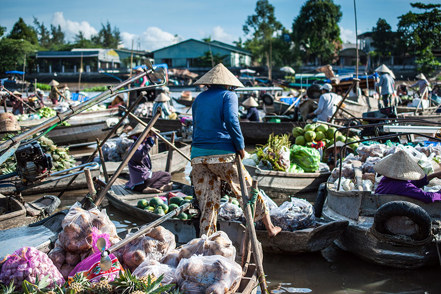 Experience a slower pace in the Mekong Delta region – and shop at a floating market!