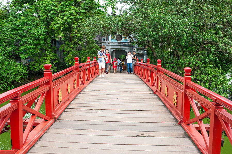 Walk across the red bridge to Hoan Kiem Lake